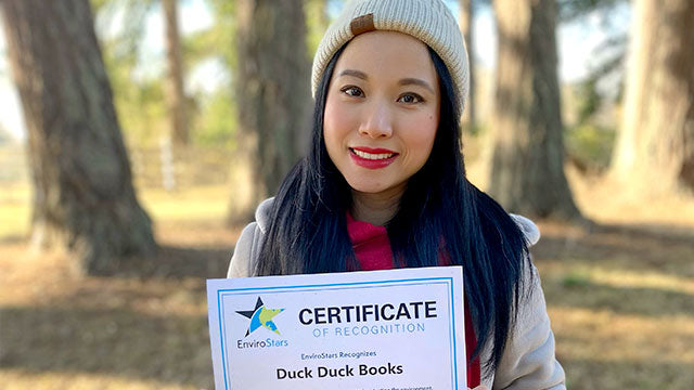 Duck Duck Books Serena Li holding EnviroStars Certificate