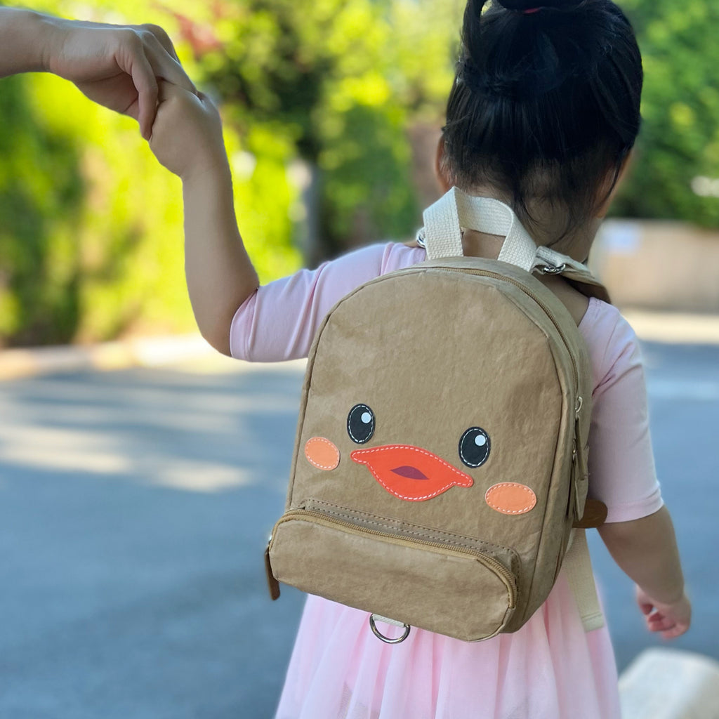 toddler wearing backpack with duck face in khaki color